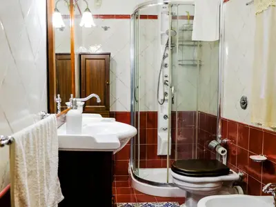 a bathroom with a toilet and a sink and a shower at Villa Carta Fashion by Interhome in Terrasini