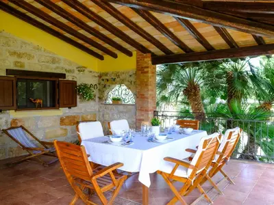 a dining room with a white table and chairs at Villa Carta Fashion by Interhome in Terrasini