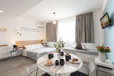 a hotel room with a bed and a table at Nerissa suites&rooms in Terrasini