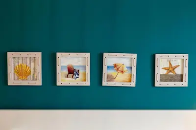 a wall with four different pictures on it at Nerissa suites&rooms in Terrasini