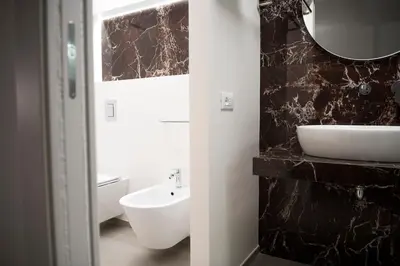 a bathroom with a white sink and a mirror at Case vacanza Puccini in Alcamo