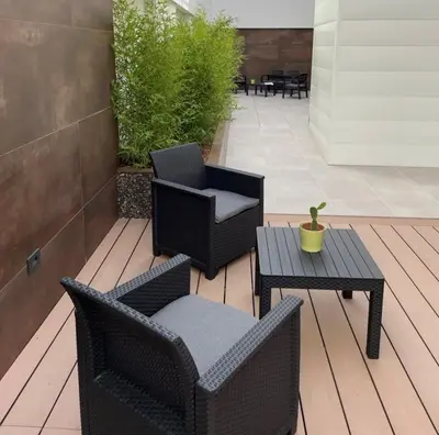 a patio with two chairs and a table at Case vacanza Puccini in Alcamo