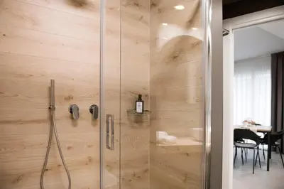 a bathroom with a shower with a glass door at Case vacanza Puccini in Alcamo