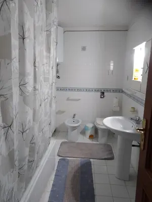 a white bathroom with a sink and a toilet at House Italia Holiday in Trabia