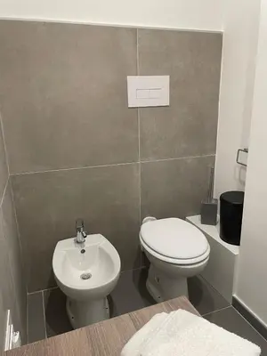 a bathroom with a toilet and a sink at Milu's Home in Palermo