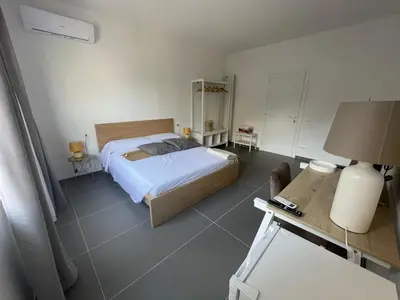 a bedroom with a bed and a table with a lamp at Milu's Home in Palermo
