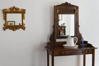 a dressing table with a mirror and a vase on it at iFlat Palazzo Ragusi in Palermo