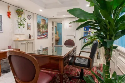 an office with a desk and a potted plant at Federico 70 Smeraldo in Palermo