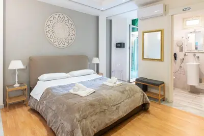 a bedroom with a large bed with towels on it at Federico 70 Smeraldo in Palermo