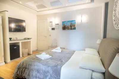 a bedroom with a bed and a couch in it at Federico 70 Smeraldo in Palermo