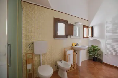 a bathroom with a toilet and a sink and a toilet istg at iFlat Casa Tesò con terrazza sui tetti in Palermo