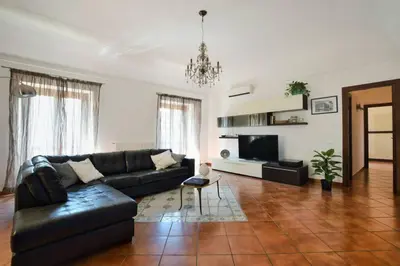 a living room with a couch and a television at iFlat Casa Tesò con terrazza sui tetti in Palermo