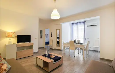 a living room with a couch and a table with a tv at 2 Bedroom Amazing Apartment In Trappeto in Trappeto