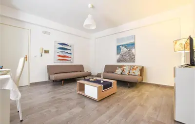 a living room with two couches and a table at 2 Bedroom Amazing Apartment In Trappeto in Trappeto