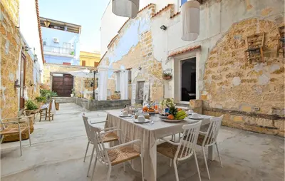a table with a bowl of fruit on top of it at 2 Bedroom Amazing Apartment In Trappeto in Trappeto