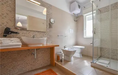 a bathroom with a sink and a toilet and a shower at 2 Bedroom Amazing Apartment In Trappeto in Trappeto