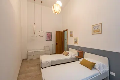 a living room with a couch and a dining room at Vucciria Apartments by Wonderful Italy in Palermo