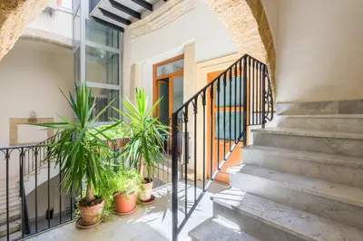 a mirror on a wall with a bed in a room at Vucciria Apartments by Wonderful Italy in Palermo