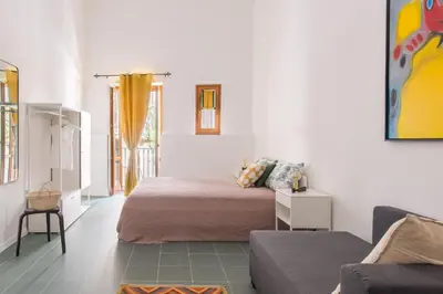 a living room with a bed and a couch at Vucciria Apartments by Wonderful Italy in Palermo