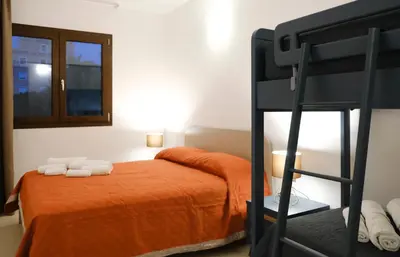 a bedroom with a bunk bed and a ladder at SOL Y MAR Camere e Appartamenti in Castellammare del Golfo