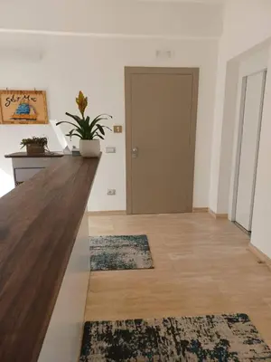 a living room with a wooden counter and a door at SOL Y MAR Camere e Appartamenti in Castellammare del Golfo