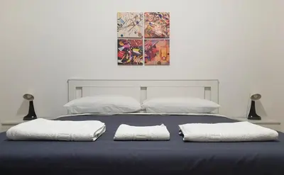 a bed with two white pillows on top of it at Sweet Home in Palermo