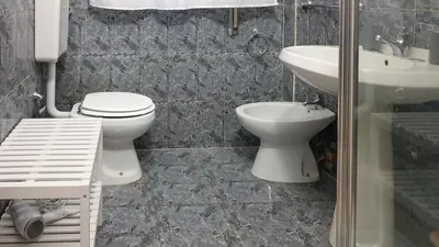 a bathroom with a toilet and a sink at Sweet Home in Palermo