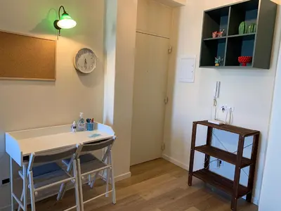 a room with a table and chairs and a clock on the wall at CALA MARE in Palermo