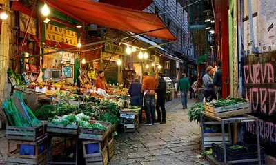 a group of people walking through an outdoor market at Monolocale Sant'Andrea in Palermo