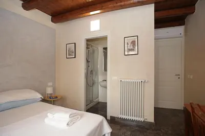 a bedroom with a bed and a shower and a toilet at Casa Miqvà - Rooms in shared apartment in Palermo