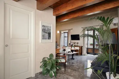 a living room with a white door and a dining room at Casa Miqvà - Rooms in shared apartment in Palermo