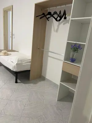 a bedroom with a bed and a book shelf at Villa Dolce Vita rooms in Castelluzzo