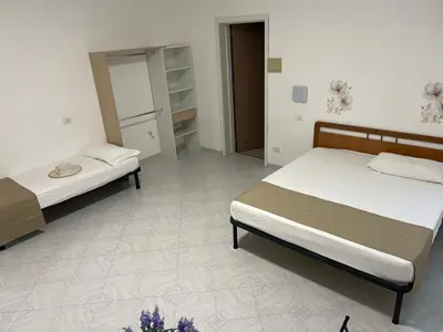 two beds sitting in a room with at Villa Dolce Vita rooms in Castelluzzo