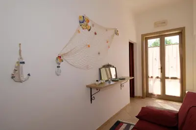 a living room with a hammock hanging on the wall at Villa Dolce Vita rooms in Castelluzzo