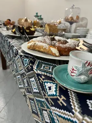 a table with plates of pastries and a cup of coffee at Villa Dolce Vita rooms in Castelluzzo