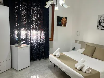 a bedroom with a bed with towels on it at Villa Dolce Vita rooms in Castelluzzo