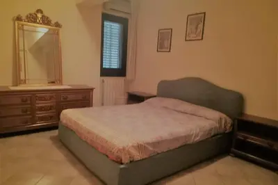 a bedroom with a bed and a dresser and a mirror at Casa del Grecale in Isola delle Femmine