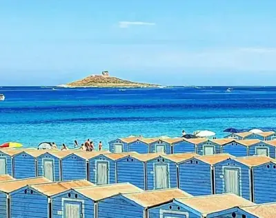 a group of houses on a beach near the ocean at Casa del Grecale in Isola delle Femmine