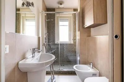 a bathroom with a toilet and a sink and a shower at Palermo old style - Boutique apartment with terrace in center city in Palermo