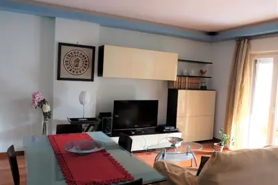 a living room with a table and a television at Palermo old style - Boutique apartment with terrace in center city in Palermo