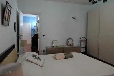 a bedroom with a white bed and a dresser at Palermo old style - Boutique apartment with terrace in center city in Palermo