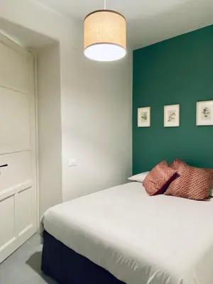a bedroom with a bed and a green wall at Da Marlà al Politeama in Palermo