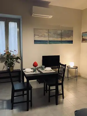 a dining room with a table and chairs and a television at Da Marlà al Politeama in Palermo