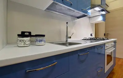 a kitchen with blue cabinets and a sink at Casa Mare in San Vito lo Capo