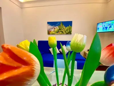 a vase with flowers in a room with a couch at Casa Mare in San Vito lo Capo