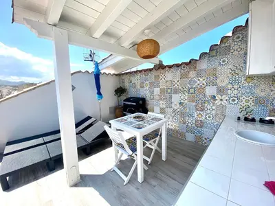 a balcony with a table and chairs on a building at Casa Sole in San Vito lo Capo