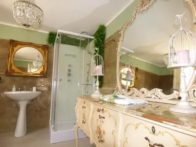 a bathroom with a large mirror and a sink at Relais dei Mori Home Palermo in Casteldaccia