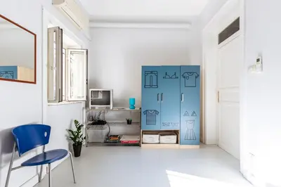 a room with a blue partition with a table and a chair at Casa Dante with Balcony by Wonderful Italy in Palermo