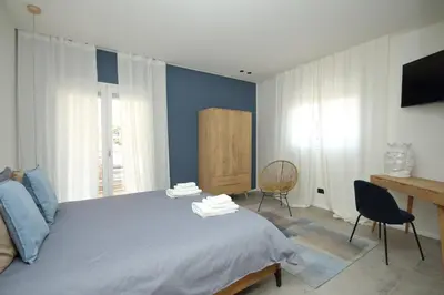 a bedroom with a bed and a desk and a chair at Al Covo dei Mori in Bagheria