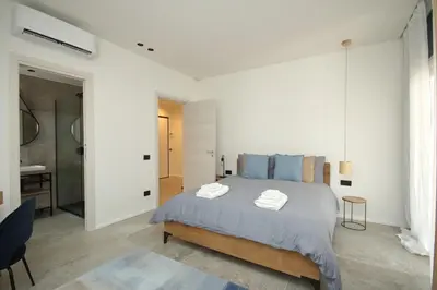 a bedroom with a large bed with two towels on it at Al Covo dei Mori in Bagheria